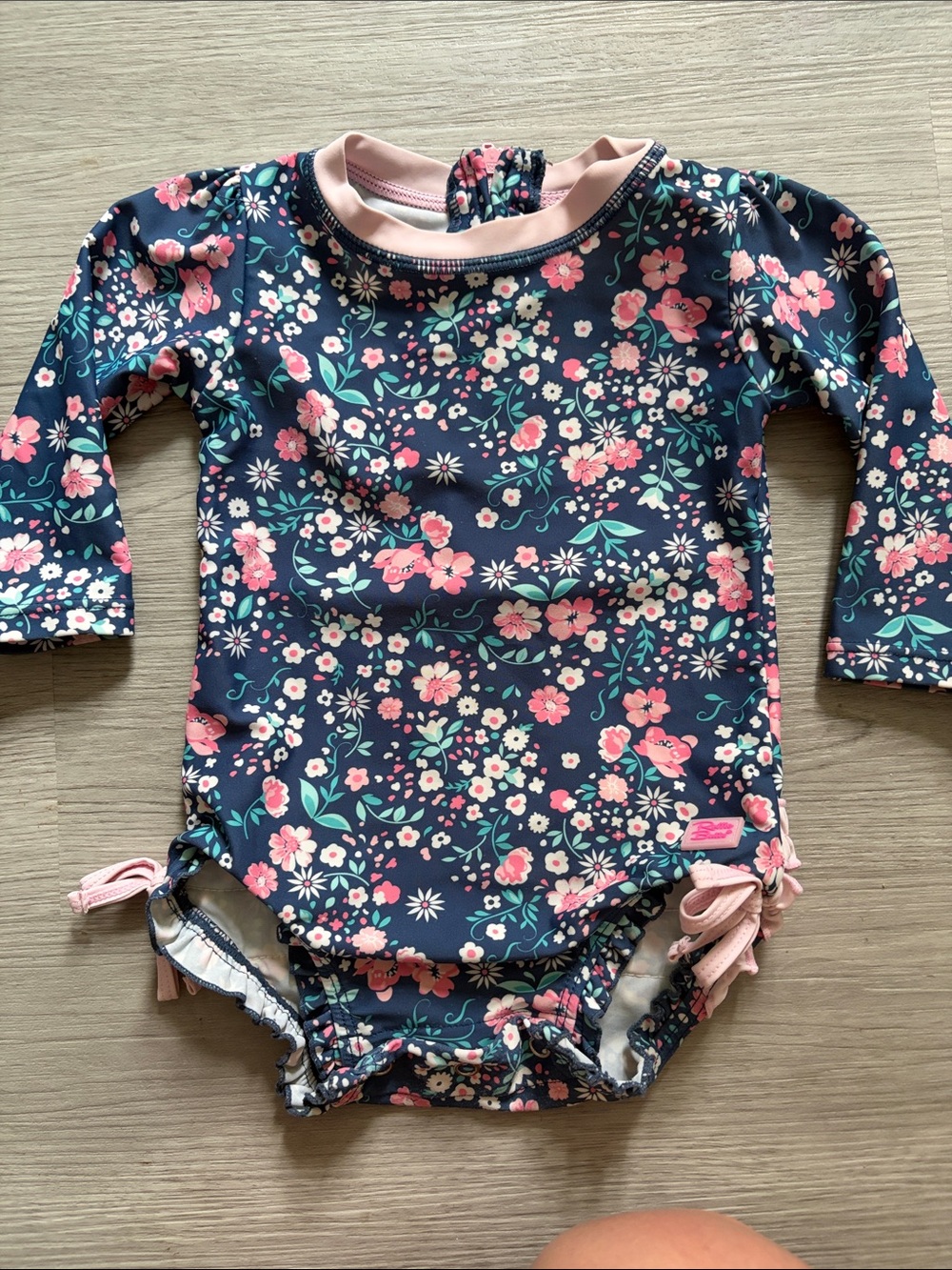 Ruffle Butts Navy Floral Long-Sleeve Baby Swimsuit with Pink Trim